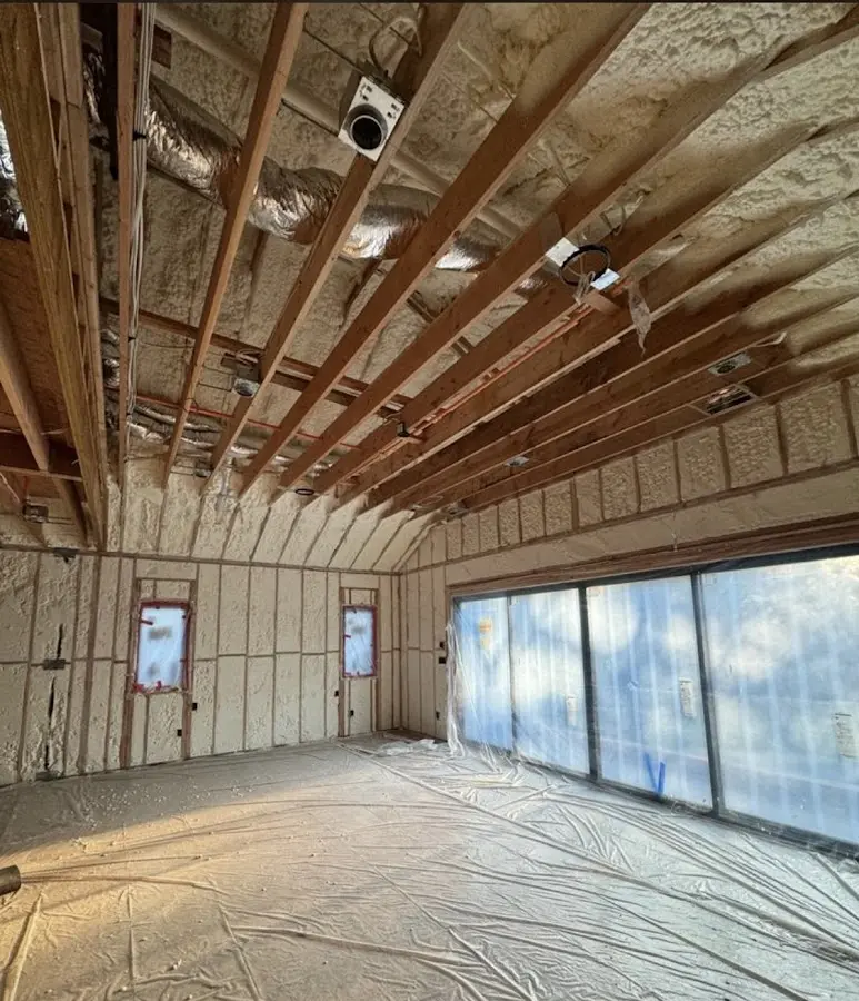 Interior walls and ceiling insulated with spray foam during new construction in Provo